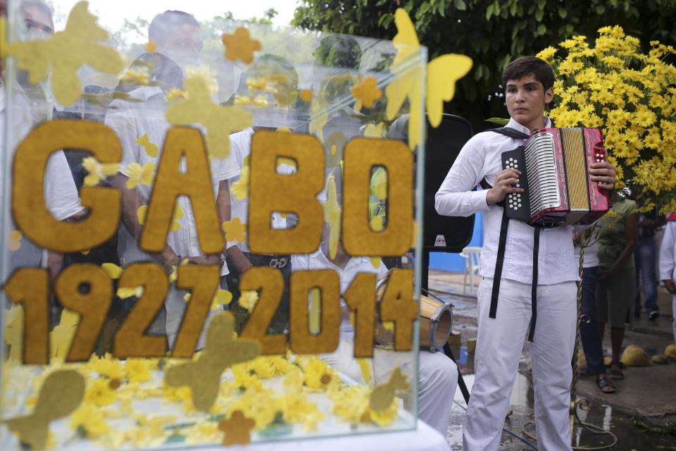 An accordionist looks at a box with messages to the late Colombian Nobel Literature laureate Gabriel Garcia Marquez during a symbolic funeral ceremony in front of the house were he was born in Aracataca, his hometown in Colombia's Caribbean coast, Monday, April 21, 2014. Garcia Marquez died at the age of 87 in Mexico City on April 17, 2014. (AP Photo/Ricardo Mazalan)