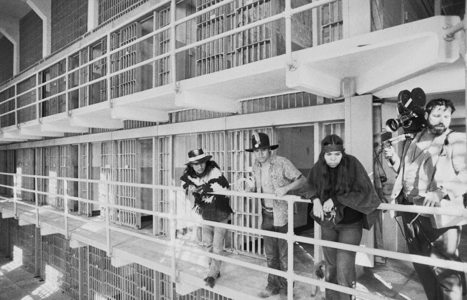 FILE - In this Nov. 19, 1969, file photo, part of a band of Native Americans look over the main cell block of Alcatraz after occupying the island in San Francisco. The week of Nov. 18, 2019, marks 50 years since the beginning of a months-long Native American occupation at Alcatraz Island in the San Francisco Bay. The demonstration by dozens of tribal members had lasting effects for tribes, raising awareness of life on and off reservations, galvanizing activists and spurring a shift in federal policy toward self-determination. (AP Photo/RWK, File)