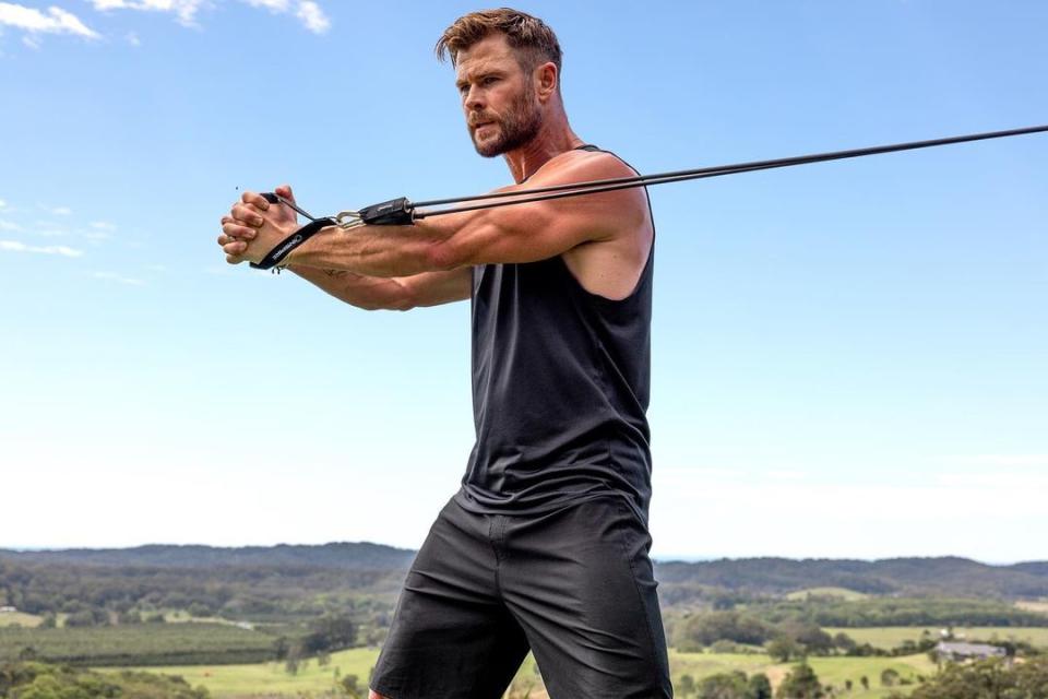 a photo of Chris Hemsworth doing a resistance band workout