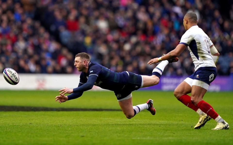 Finn Russell passes the ball high off the ground