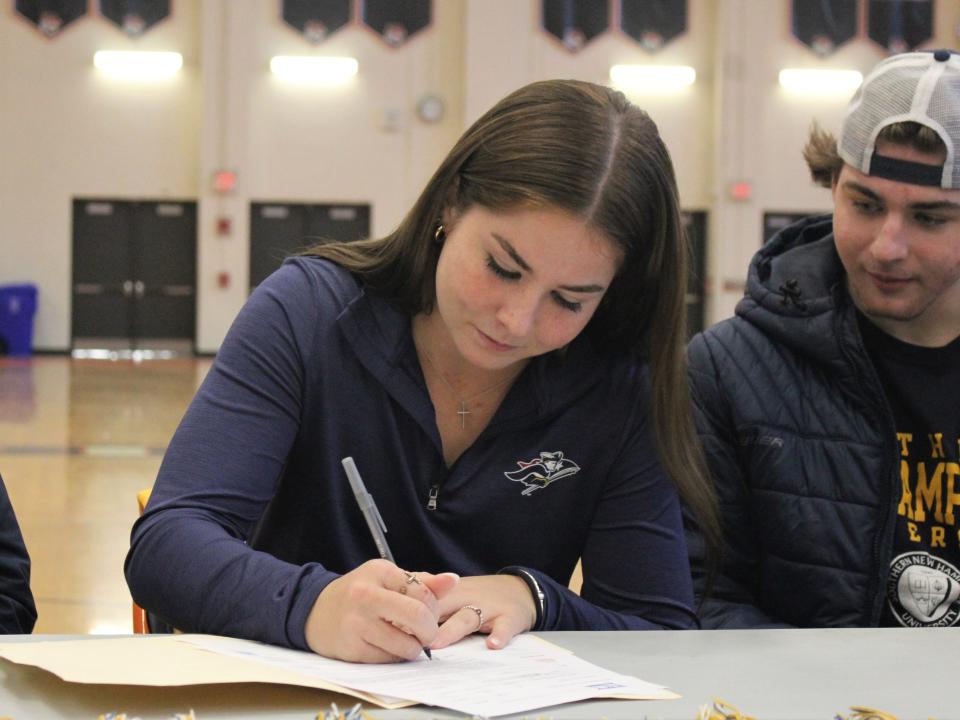 Taunton softball's Kaysie DeMoura signs her National Letter of Intent to play for Southern New Hampshire University while brother Jack DeMoura watches on during a signing ceremony on Nov. 14, 2022.