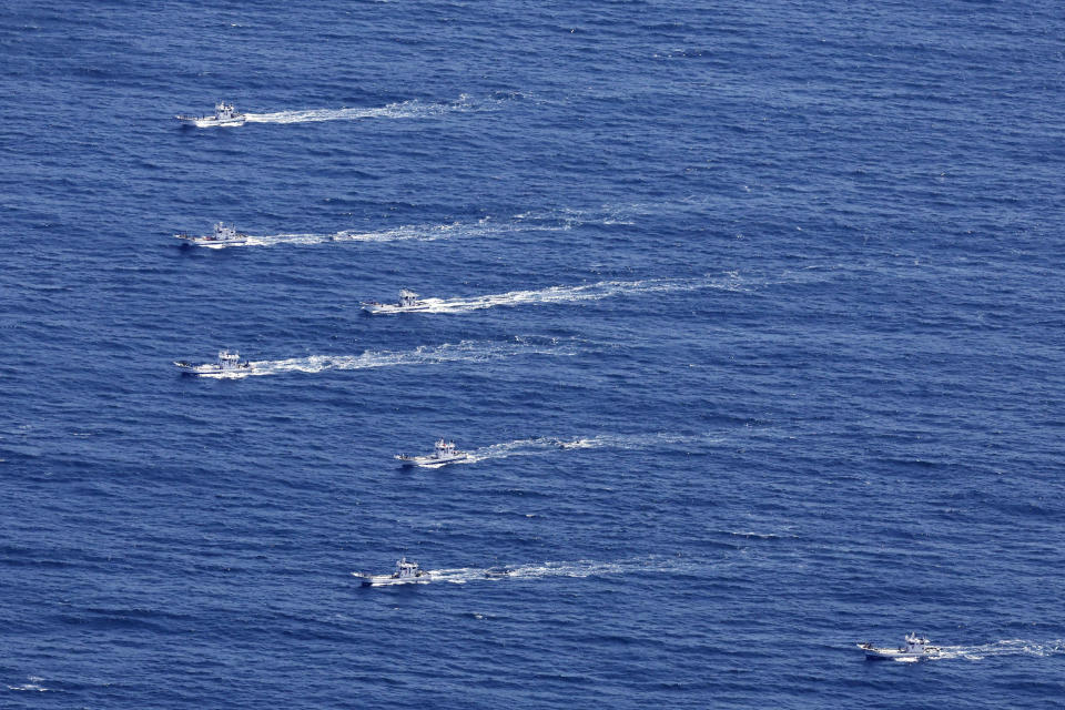 This aerial photo shows the fishing boats conduct search operations for the passengers and crew members on a missing tour boat, off Shiretoko Peninsula, northern Japan of Hokkaido Sunday, April 24, 2022. The Japanese Coast Guard said Sunday that rescue helicopters found several of the 26 people from a tour boat missing in the frigid waters of northern Japan since the day before, but their conditions are unknown. (Masanori Takei/Kyodo News via AP)