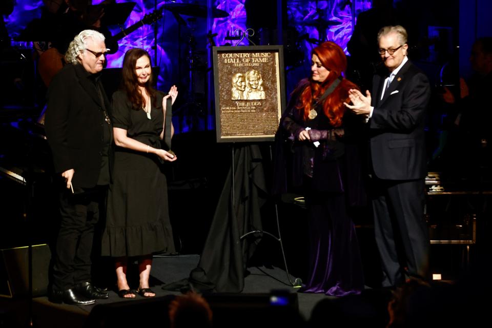 Wynonna Judd (second from the right) and sister Ashley Judd (left) stand next to the Judds' induction plaque during the Medallion Ceremony at the Country Music Hall of Fame on Sunday, May 1, 2022, in Nashville, Tenn.