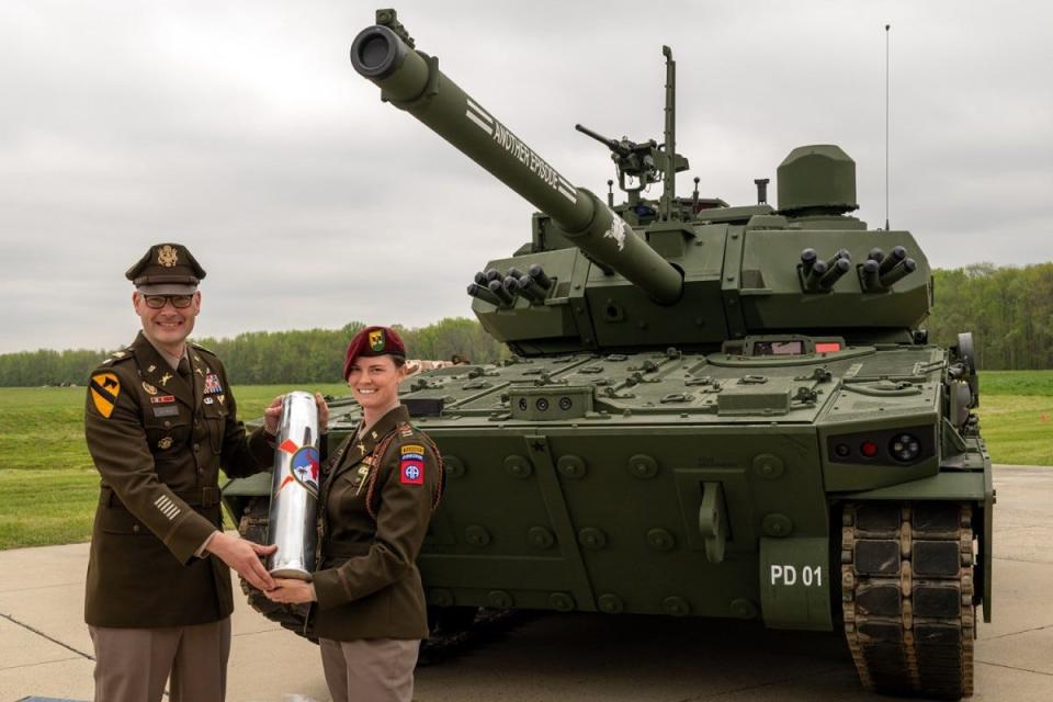 Capt. Rachel Ledbetter, company commander of the M10 Booker Test Detachment, 82nd Airborne Division at Fort Liberty receives a ceremonial shell casing during the M10 Booker dedication ceremony April 18, 2024, at Aberdeen Proving Ground, in Aberdeen, Maryland.