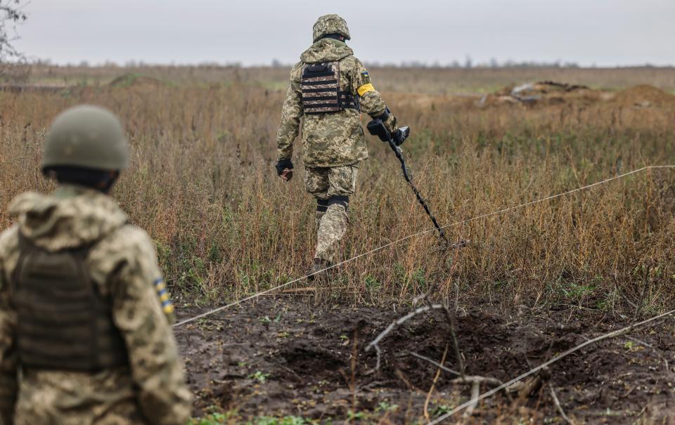 Ukrainian troops search for mines on recaptured land north of Kherson (EPA)