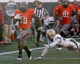 Oklahoma State running back Herschel Sims, left, runs 81 yards for a touchdown against Baylor in the fourth quarter of an NCAA college football game in Stillwater, Okla., Saturday, Oct. 29, 2011. Oklahoma State won 59-24. Baylor's Joe Williams attempts a tackle at right. Oklahoma State won 59-24. (AP Photo/Sue Ogrocki)