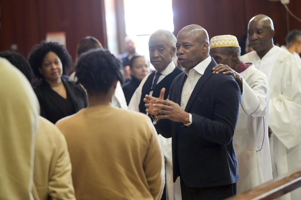 In this photo provided by the Office of the Mayor of New York, Mayor Eric Adams, center right, participates in a baptism ceremony while visiting the Rikers Island jail complex in New York, Friday, March 29, 2024. (Ed Reed/Mayoral Photography Office via AP)