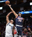 Houston Rockets center Christian Wood (35) reaches for a rebound over Dallas Mavericks center Dwight Powell (7) during the first half of an NBA basketball game Friday, Jan. 7, 2022, in Houston. (AP Photo/Eric Christian Smith)