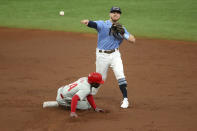 Tampa Bay Rays second baseman Michael Brosseau, top, throws over Philadelphia Phillies' Roman Quinn to complete a double play against batter Andrew McCucthen during the third inning of a baseball game Sunday, Sept. 27, 2020, in St. Petersburg, Fla. (AP Photo/Mike Carlson)