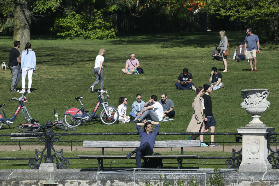 People enjoy the weather in Kensington Gardens, as the UK continues its lockdown to help curb the spread of coronavirus, in London, Saturday April 25, 2020. (Jonathan Brady/PA via AP)