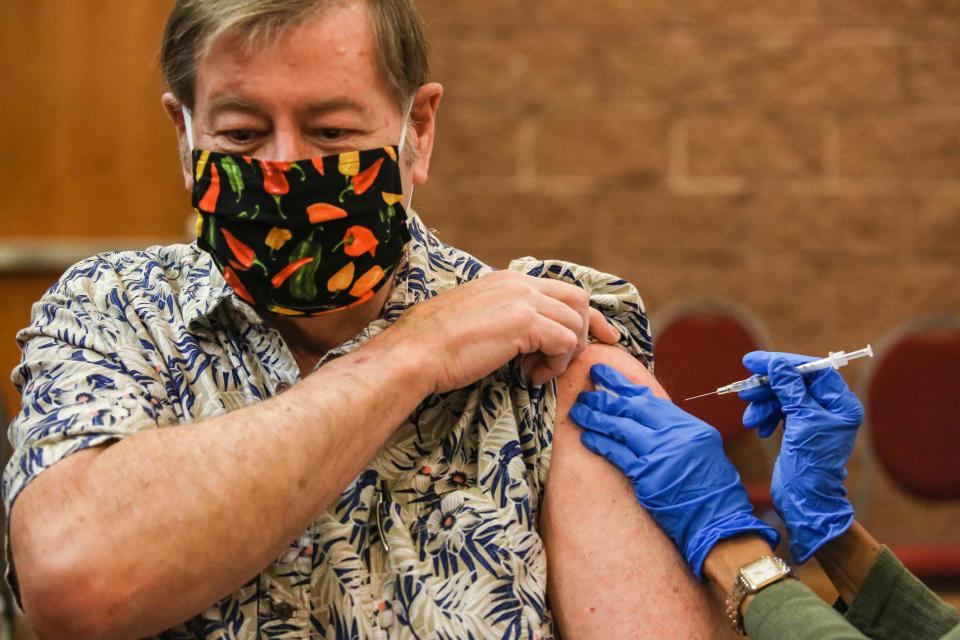 Gregory Blok receives a vaccine at a clinic offering COVID-19 vaccinations at the New Mexico Farm & Ranch Heritage Museum in Las Cruces on Tuesday, Oct. 19, 2021.