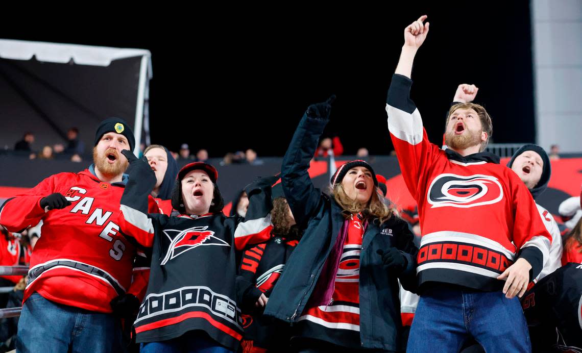 From left, Matt Boggs, his wife, Nondi Boggs, Hayley Looney and Jonathan Boggs cheer on the Canes during the second period of the NHL Stadium Series game between the Carolina Hurricanes and the Washington Capitals at Carter-Finley Stadium in Raleigh, N.C., Saturday, Feb. 18, 2023.