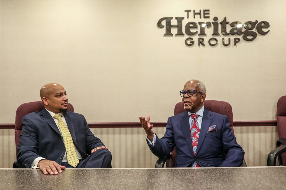 CEO of the National Business League INC. (the oldest and largest trade association for Black Businesses) Ken Harris, left, meets with the owner of Heritage Optical, George P. Barnes Jr. in Detroit on Friday, Jan. 21, 2022. 