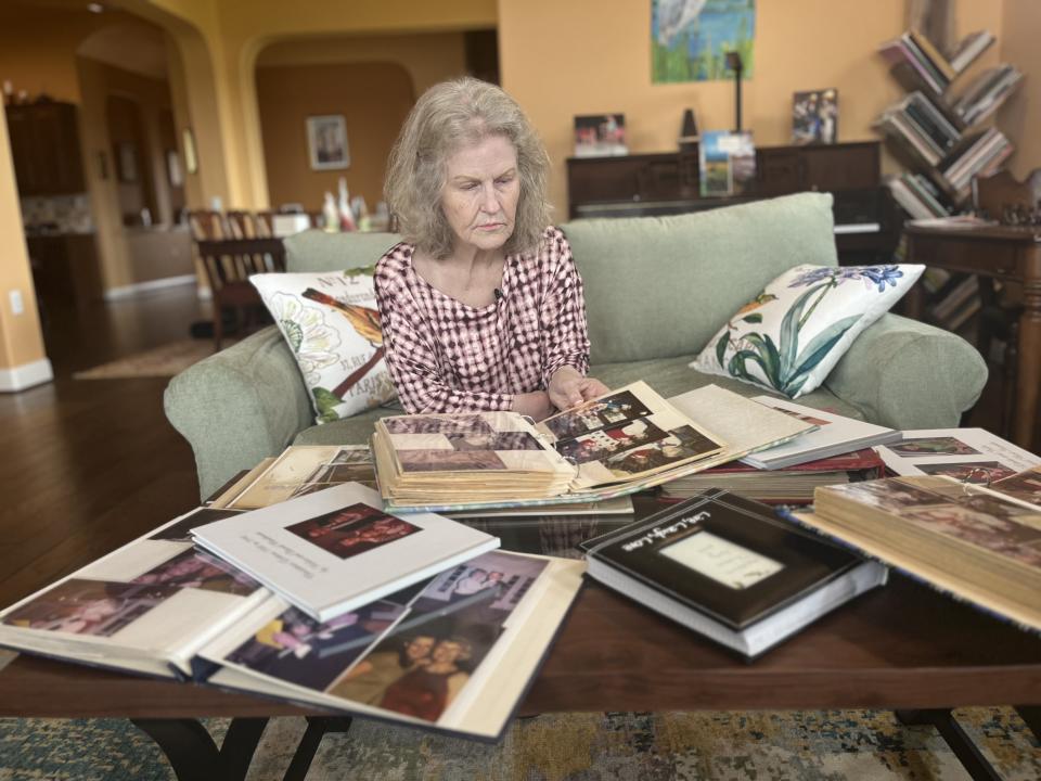 
            woman looking at photo albums

        