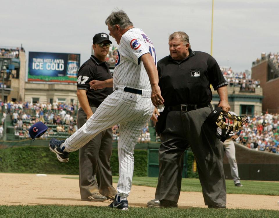 Chicago Cubs manager Lou Piniella, center, kicks his hat as he argues with third base umpire Mark Wegner, left, and home plate umpire Bruce Froemming watches during the eighth inning of a game against Atlanta Braves, Saturday, June 2, 2007, in Chicago. Piniella was ejected by Wegner.(AP Photo/Nam Y. Huh)