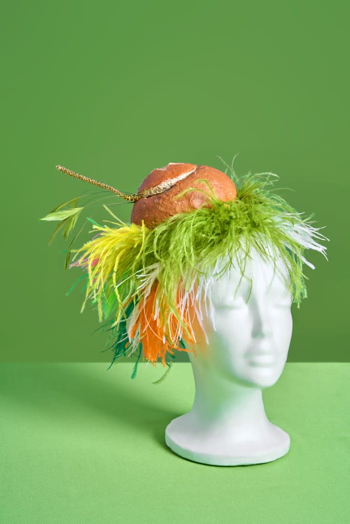The derby-inspired fascinator pays homage to the restaurant’s broccoli cheddar soup bread bowl, with color-coordinated feathers and a golden spoon. Panera