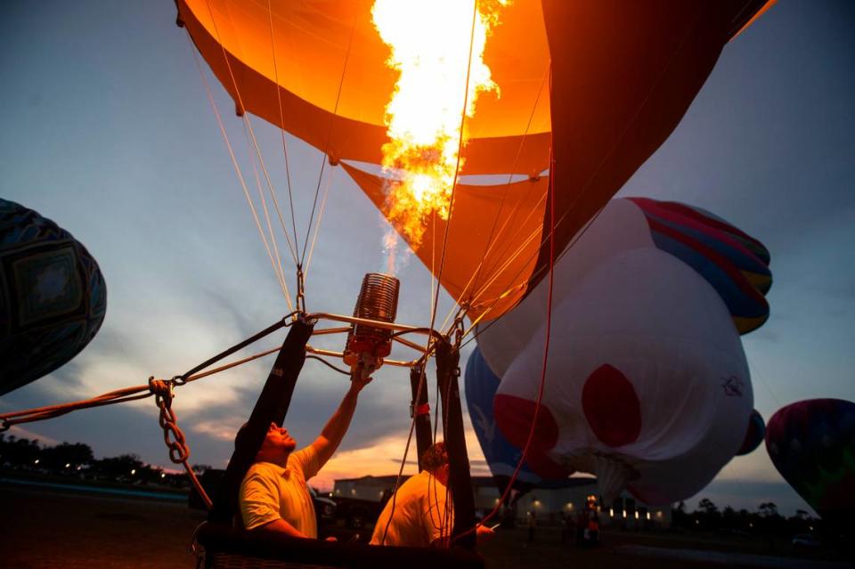 A hot air balloon pilot fires the burners inside his balloon during the Gulf Coast Hot Air Balloon Festival at OWA in Foley, Alabama on Thursday, May 4, 2023.