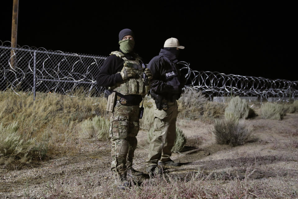 Police officers guard an entrance to the Nevada Test and Training Range near Area 51, Sept. 20, 2019, near Rachel, Nev. People gathered at the gate inspired by the "Storm Area 51" internet hoax.  (Photo: John Locher/AP)