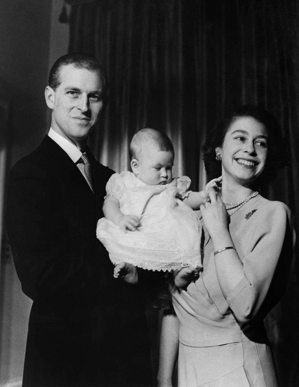 Posing with their son, Prince Charles. [Photo: Getty]