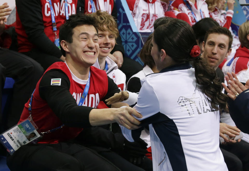 Patrick Chan of Canada, left, congratulates Valentina Marchei of Italy after she competed in the women's team free skate figure skating competition at the Iceberg Skating Palace during the 2014 Winter Olympics, Sunday, Feb. 9, 2014, in Sochi, Russia. (AP Photo/Darron Cummings, Pool)