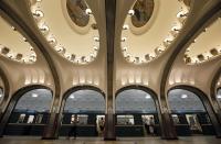 A woman walks on the platform as a train arrives at Mayakovskaya metro station, which was built in 1938, in Moscow August 17, 2013. To step onto the Moscow metro is to step back in time and immerse yourself in a museum rich in architecture and history. Opened in 1935, it is an extravagant gallery of Communist design, featuring Soviet artworks, statues, chandeliers, stained glass and ceiling mosaics. Built under Stalin, the metro now transports 7 to 9 million people a day and costs 30 Rubles, around $1, for a single ride. Picture taken August 17, 2013. REUTERS/Lucy Nicholson (RUSSIA - Tags: SOCIETY TRANSPORT TPX IMAGES OF THE DAY) ATTENTION EDITORS: PICTURE 05 OF 24 FOR PACKAGE 'RIDING THE MOSCOW METRO' SEARCH 'MOSCOW CHANDELIERS' FOR ALL IMAGES