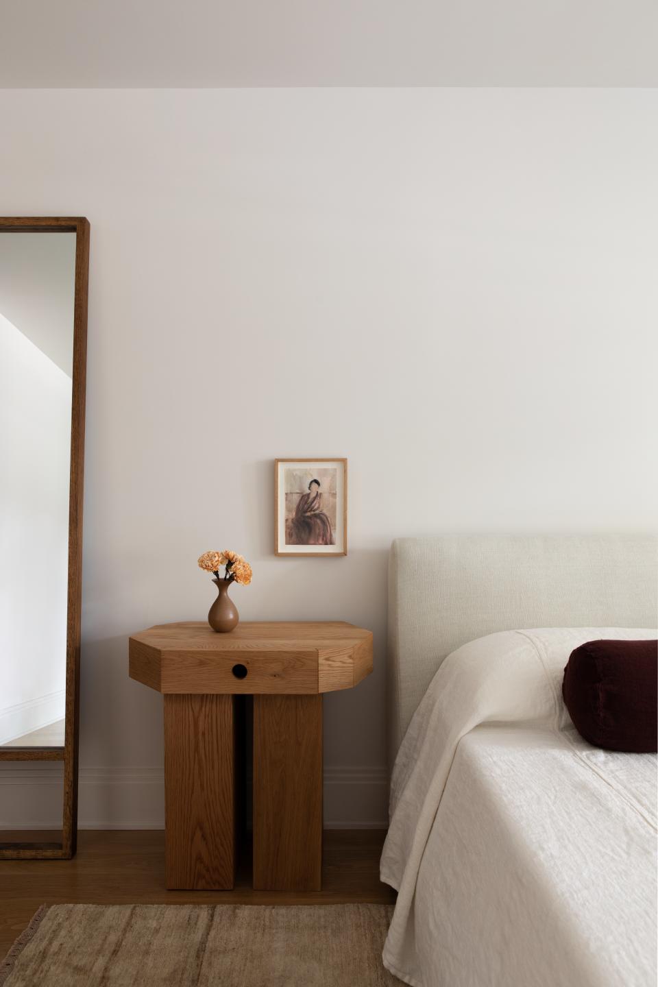 Minimalist bedroom with wooden side table