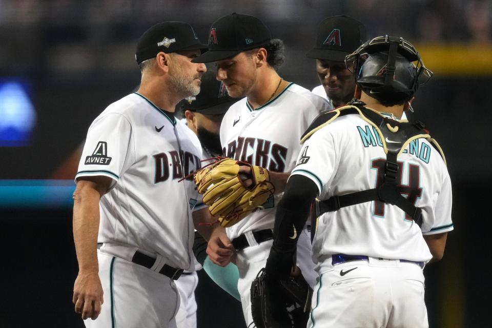 Arizona Diamondbacks manager Torey Lovullo (left) takes the ball from starting pitcher Brandon Pfaadt (32) during the sixth inning against the Philadelphia Phillies in game three of the NLCS of the 2023 MLB playoffs at Chase Field in Phoenix on Oct. 19, 2023.