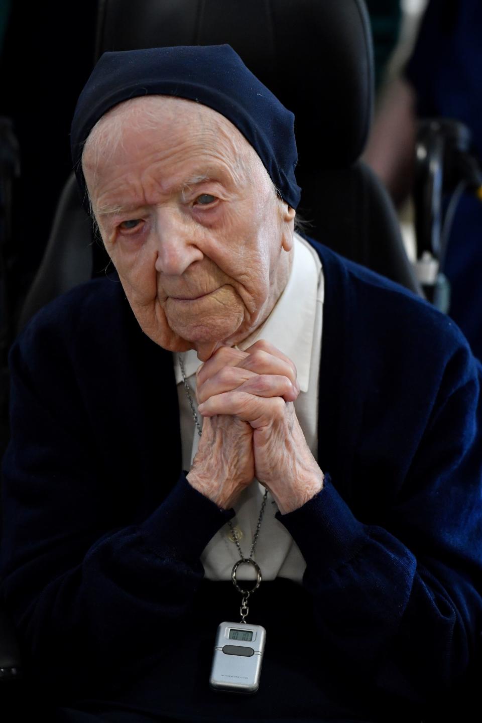 Sister Andre (C), Lucille Randon in the registry of birth, the eldest French citizen, looks on during an event to celebrate her 116th birthday in the EHPAD (Housing Establishment for Dependant Elderly People) in Toulon, southern France, where she has been living since 2009. - Sister Andre was born February 11, 1904. (Photo by GERARD JULIEN / AFP) (Photo by GERARD JULIEN/AFP via Getty Images)