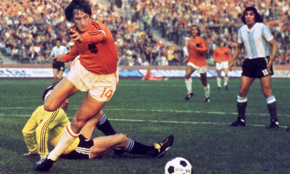 <span>Dutch midfielder Johan Cruyff dribbles past Argentina goalkeeper Daniel Carnevali on his way to scoring in the 1974 World Cup quarter-final in Gelsenkirchen.</span><span>Photograph: STF/AFP/Getty Images</span>