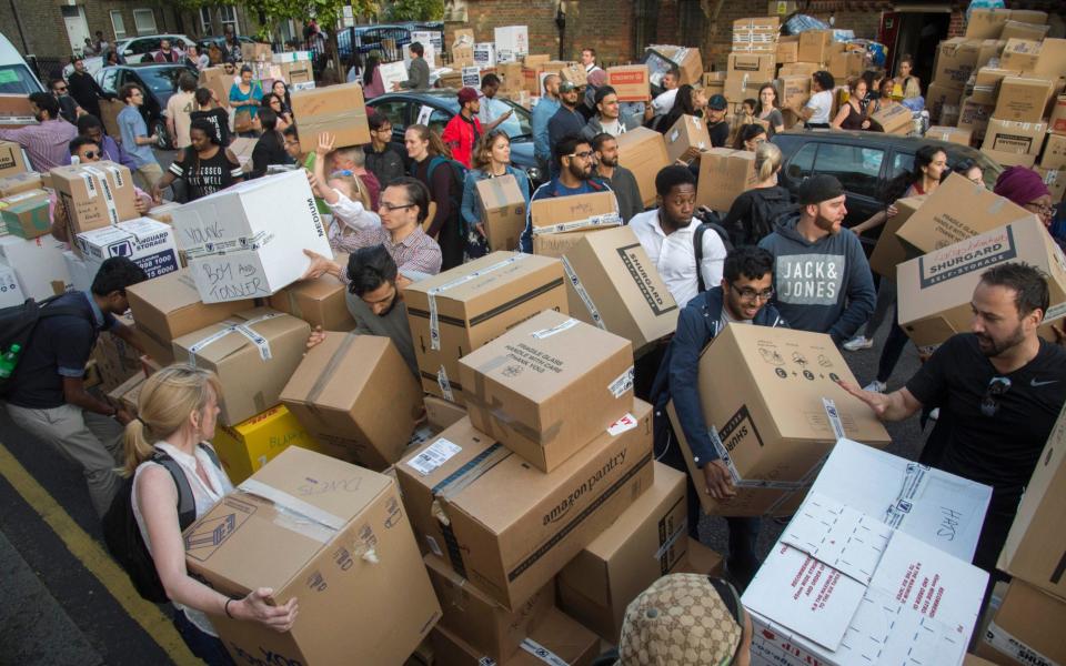 Local Volunteers transport donated goods after the tragedy - Credit: Paul Grover/The Telegraph