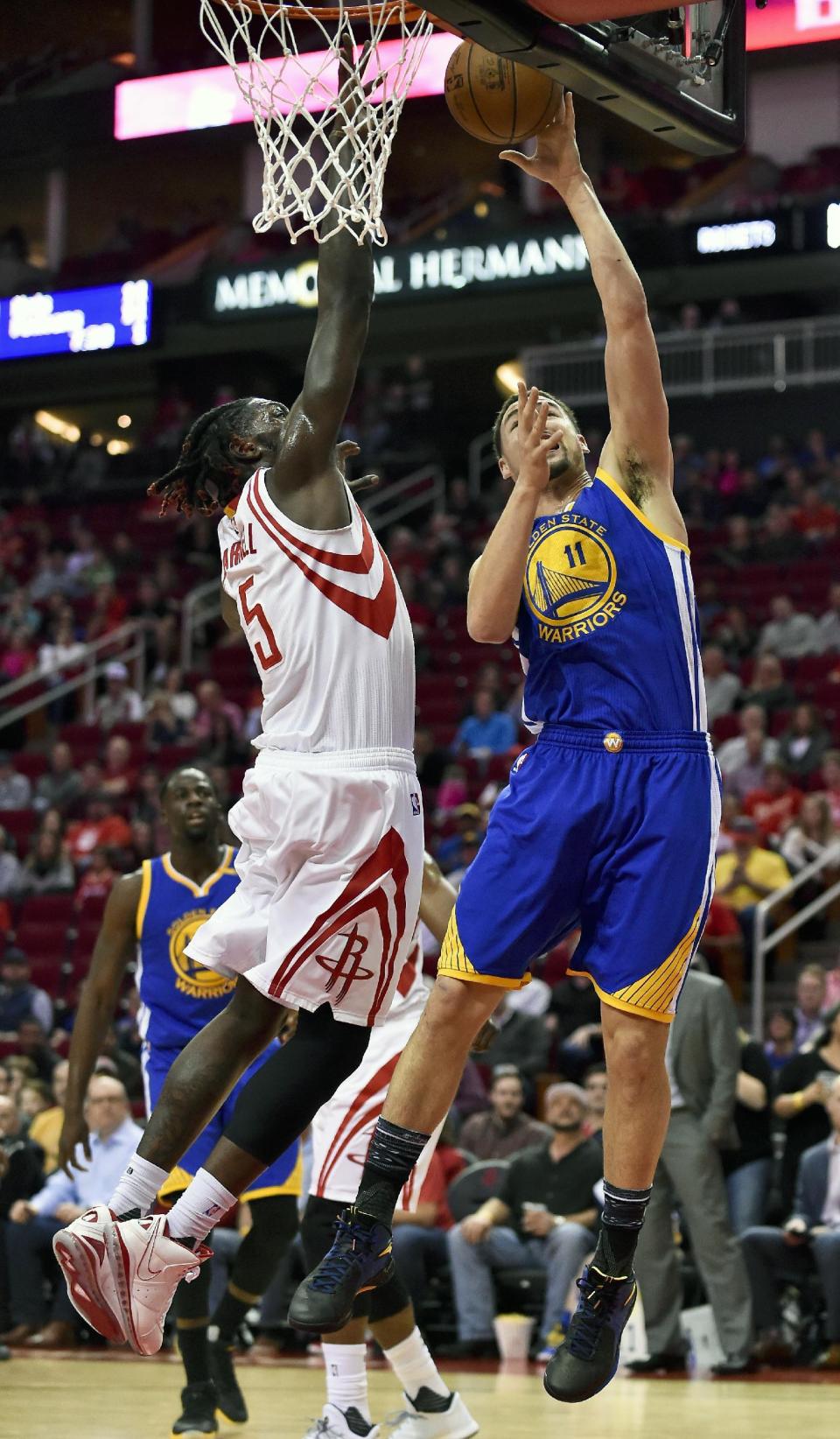 Golden State Warriors guard Klay Thompson (11) shoots as Houston Rockets forward Montrezl Harrell (5) defends during the first half of an NBA basketball game, Friday, Jan. 20, 2017, in Houston. (AP Photo/Eric Christian Smith)