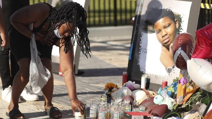 Family members and friends of Tyre Sampson leave items during a vigil in front of the Orlando Free Fall drop tower in ICON Park in Orlando, Florida. Sampson, 14, was killed last month when he fell from the ride. (Photo: Stephen M. Dowell/Orlando Sentinel via AP)