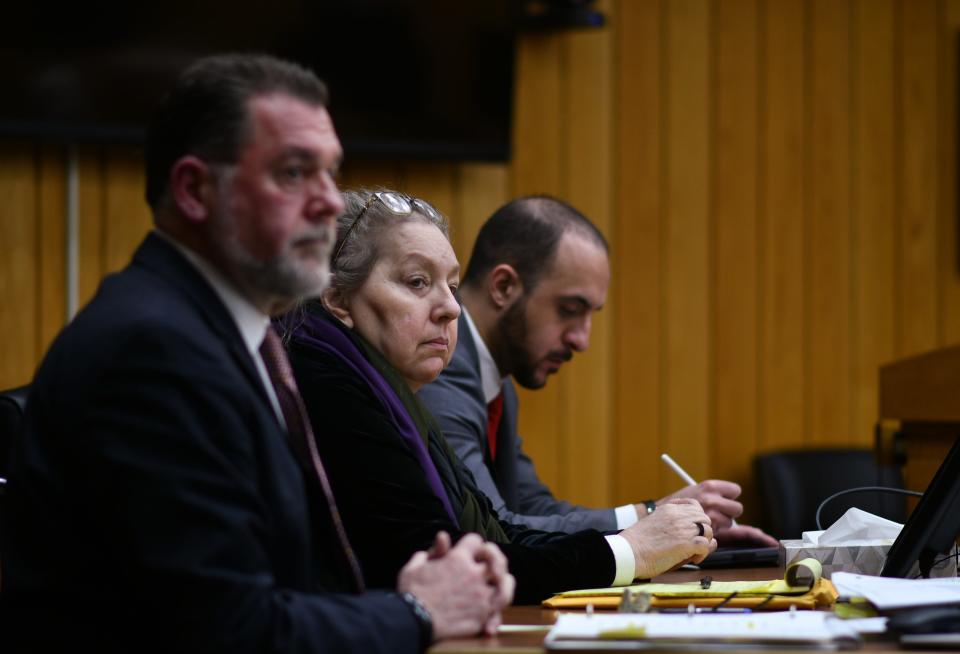 Flanked by her attorneys Timothy Havis, left, and John Finley, Beverly McCallum appears in Judge Janice Cunningham's courtroom in Eaton County, Friday, March 29, 2024. She is charged with second-degree murder and disinterment and mutilation of a body in connection with the death of her husband, Roberto Caraballo, in 2002.