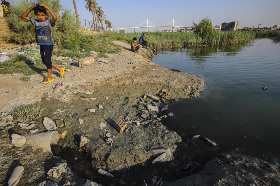 A child walks on the bank of the Shatt al-Arab waterway in Basra, Iraq on July 13, 2020. Iraq’s minister of water resources said Thursday, July 16, 2020 that severe shortages loom ahead if Iraq and neighboring Turkey fail to strike agreements over irrigation and dam projects. (AP Photo/Nabil al-Jurani)