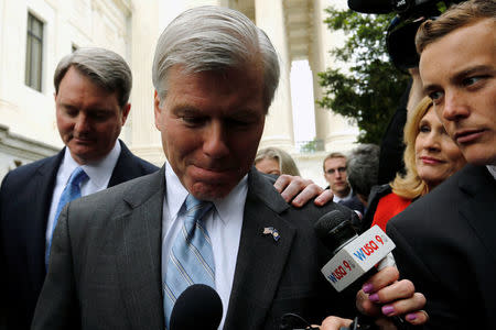 Former Virginia Governor Bob McDonnell is trailed by reporters as he departs after his appeal of his 2014 corruption conviction was heard at the U.S. Supreme Court in Washington, U.S. April 27, 2016. REUTERS/Jonathan Ernst