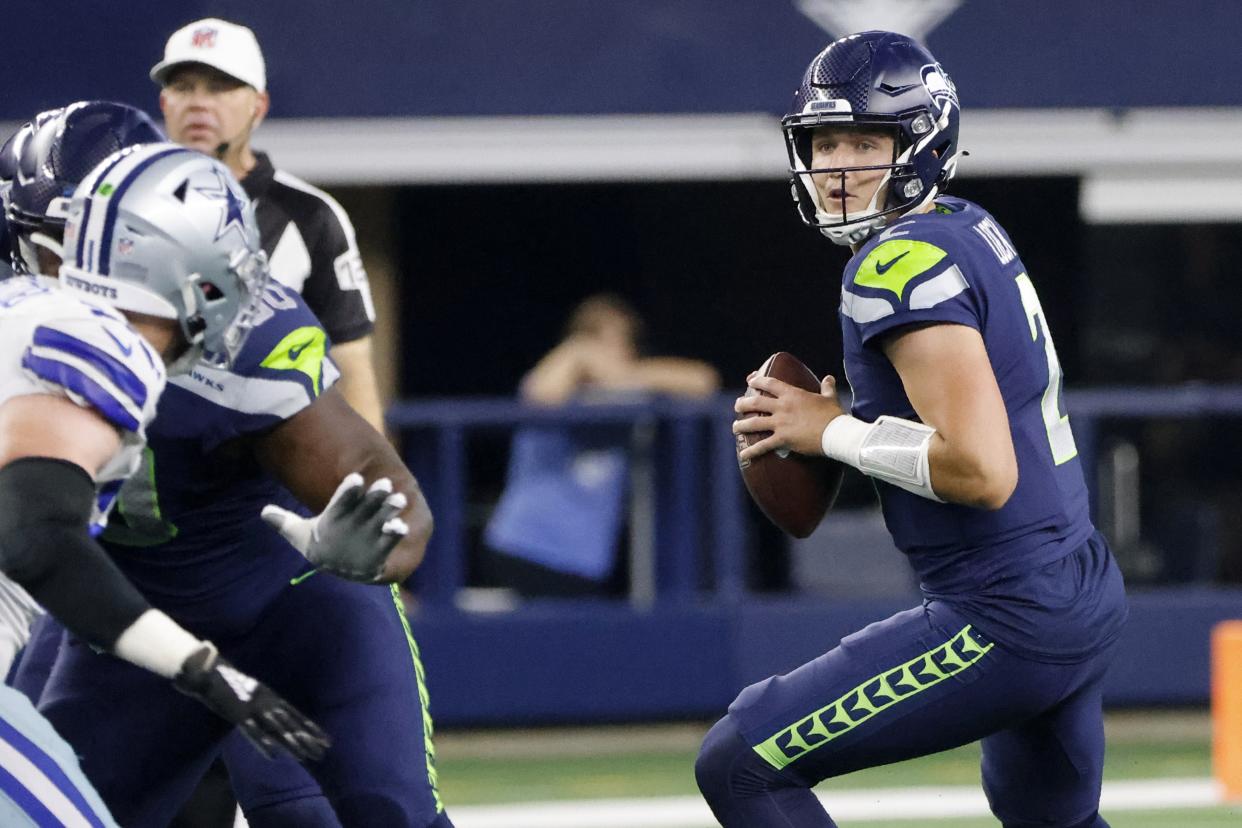 Seattle Seahawks quarterback Drew Lock (2) drops back to throw a pass against the Cowboys. (AP Photo/Michael Ainsworth)