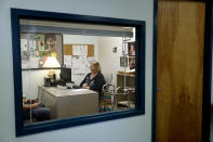 In this Tuesday, March 21, 2017, photo, Mary Lytle-Gaines meets with a client in her office in St. Louis. With her mobile home paid off, the 61-year-old social worker had hoped to semi-retire next year and work part time, but now with insurance premiums likely to rise for her age group and income level she believes that may not be possible. (AP Photo/Jeff Roberson)