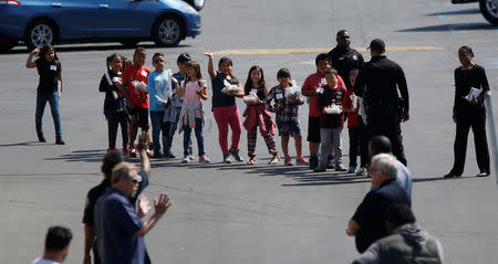 REFILE -- CORRECTING TYPO -- Students who were evacuated after a shooting at North Park Elementary School walk past well-wishers to be reunited with their waiting parents at a high school in San Bernardino, California, U.S. April 10, 2017. REUTERS/Mario Anzuoni