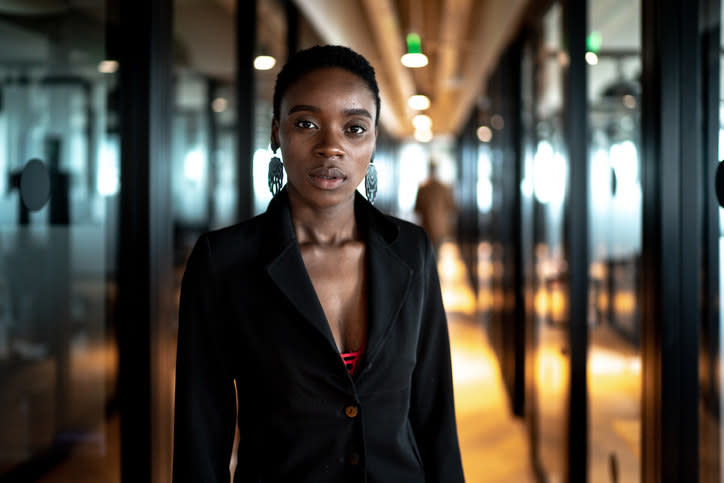 A woman in a business suit looking into the camera.