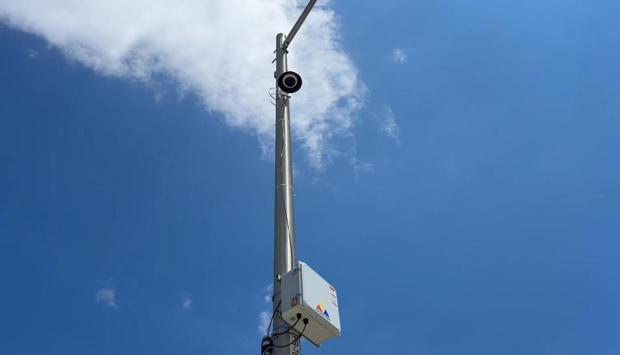 A photo of the camera system installed on a light post on Joseph Street. The president of Ramudden Digital, Michael McGuire, said the each camera has a physical box nearby containing a computer for processing and a communications system to upload processed data to the cloud.  (Cameron Mahler/CBC - image credit)