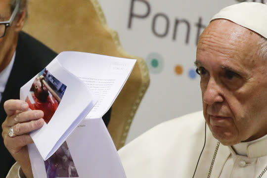 <p>Pope Francis shows pictures of killed children during a meeting with the Scholas Occurrentes, an educational organization founded by the pontiff, at the Vatican, Sunday, May 29, 2016. <em>(AP Photo/Gregorio Borgia)</em> </p>