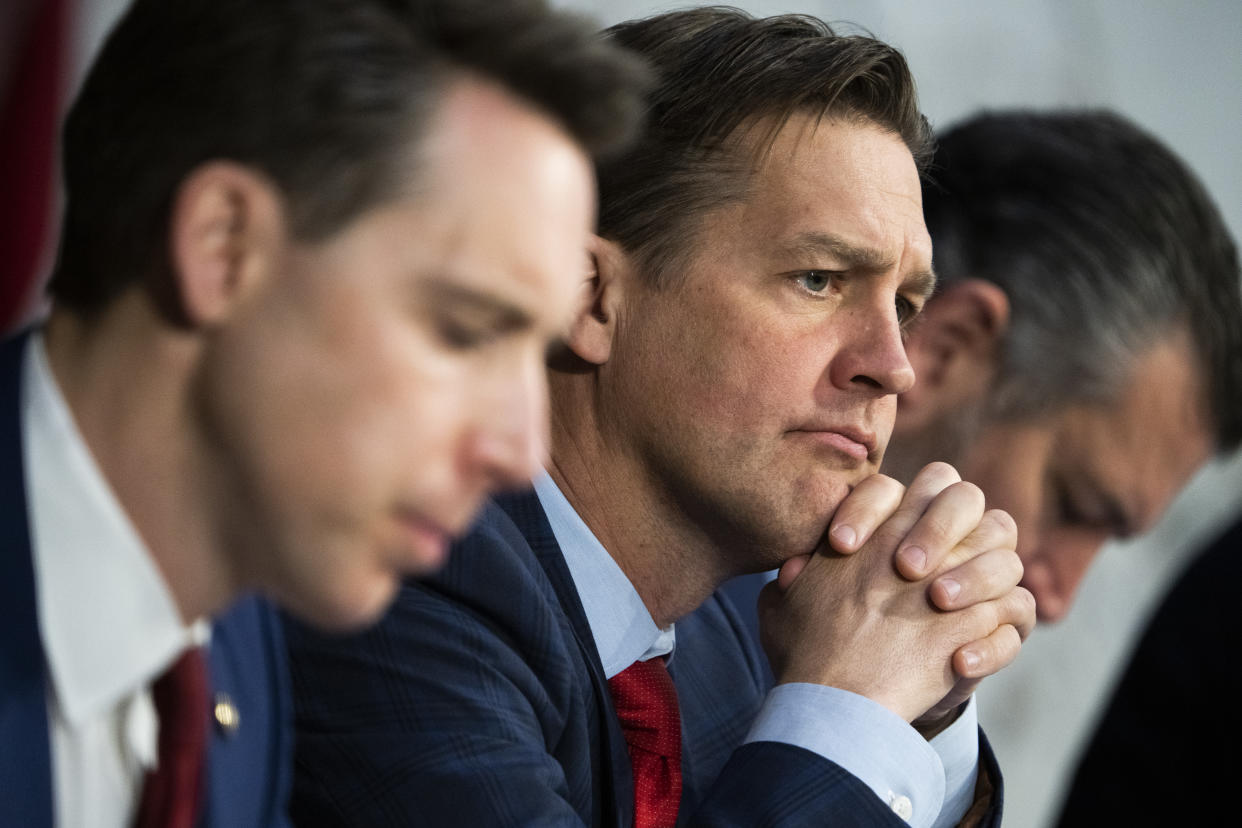 Sen. Ben Sasse wears a quizzical look as he listens carefully to testimony, as his neighbors, Sens. Josh Hawley and Ted Cruz, seem absorbed in other things.