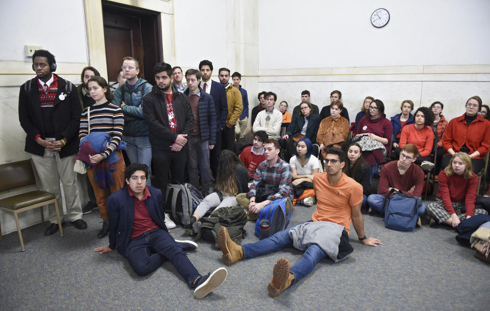 Students from Yale and Harvard University along with members of the Greater New Haven community charged with disorderly conduct after a protest interrupted the annual Yale Harvard football game, wait in Superior Court in New Haven, Connecticut, for their arraignments on Friday, Dec. 6, 2019. (Arnold Gold/New Haven Register via AP, Pool)