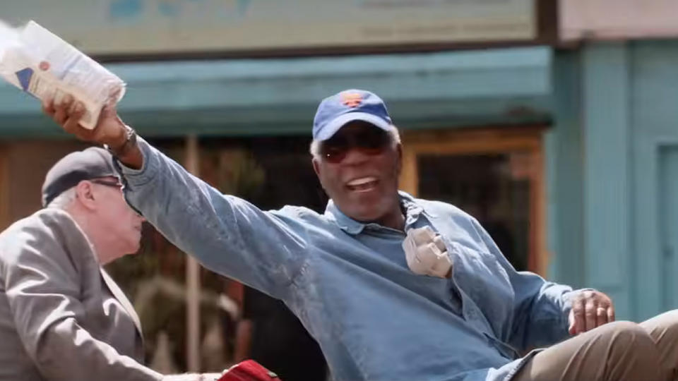 Morgan Freeman smiling and throwing flour