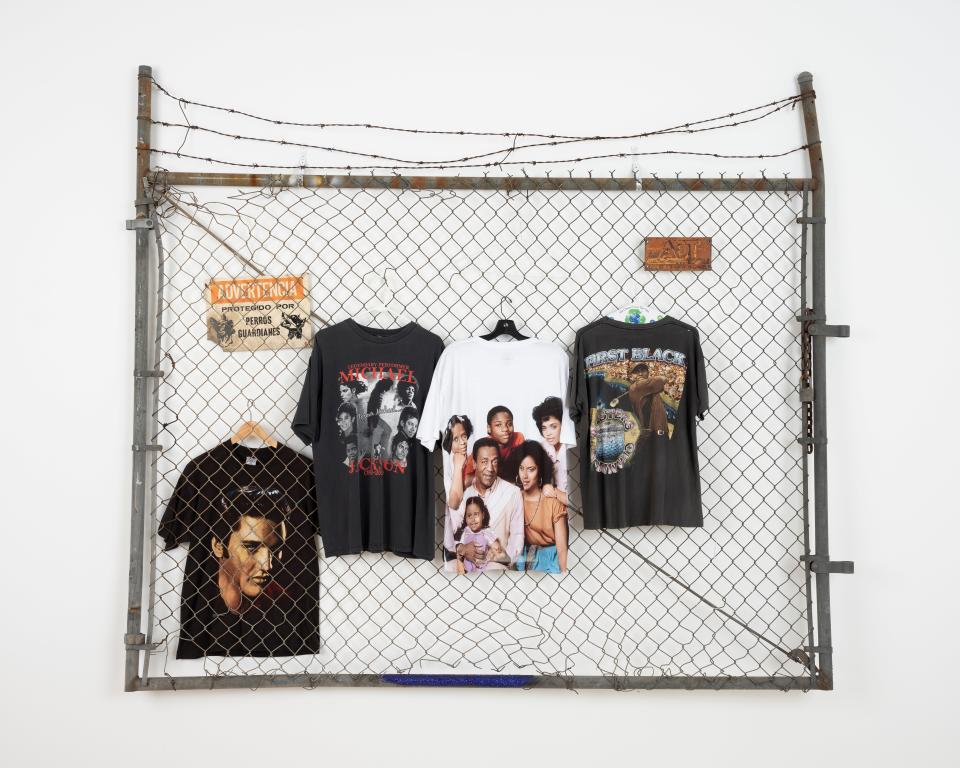 So many clothes I ran out of hangers (Black, White & Grass), 2019
Metal fence with barbed wire, assorted tees on hangars
82 x 98 x 9 inches