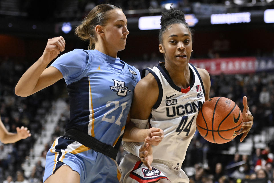 Marquette's Emily La Chapell (21) guards against UConn's Aubrey Griffin (44) during the second half of an NCAA college basketball game in the semifinals of the Big East Conference tournament at Mohegan Sun Arena, Sunday, March 5, 2023, in Uncasville, Conn. (AP Photo/Jessica Hill)