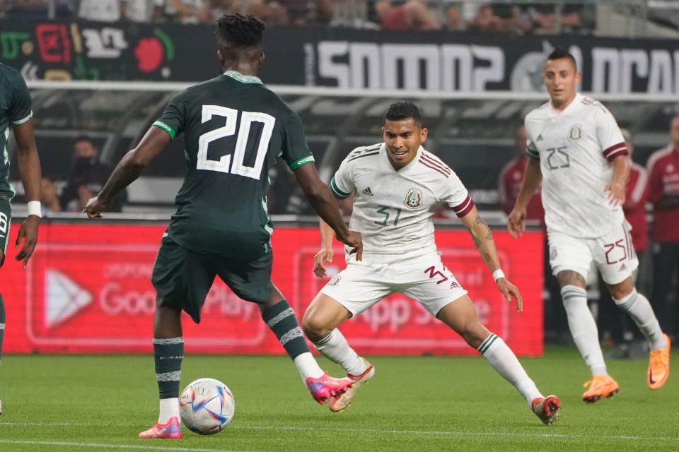 May 28, 2022; Arlington, TX, USA; Nigeria defender Chidozie Awaziem (20) controls the ball against Mexico midfielder Orbelin Pineda (31) during the second half at AT&T Stadium.