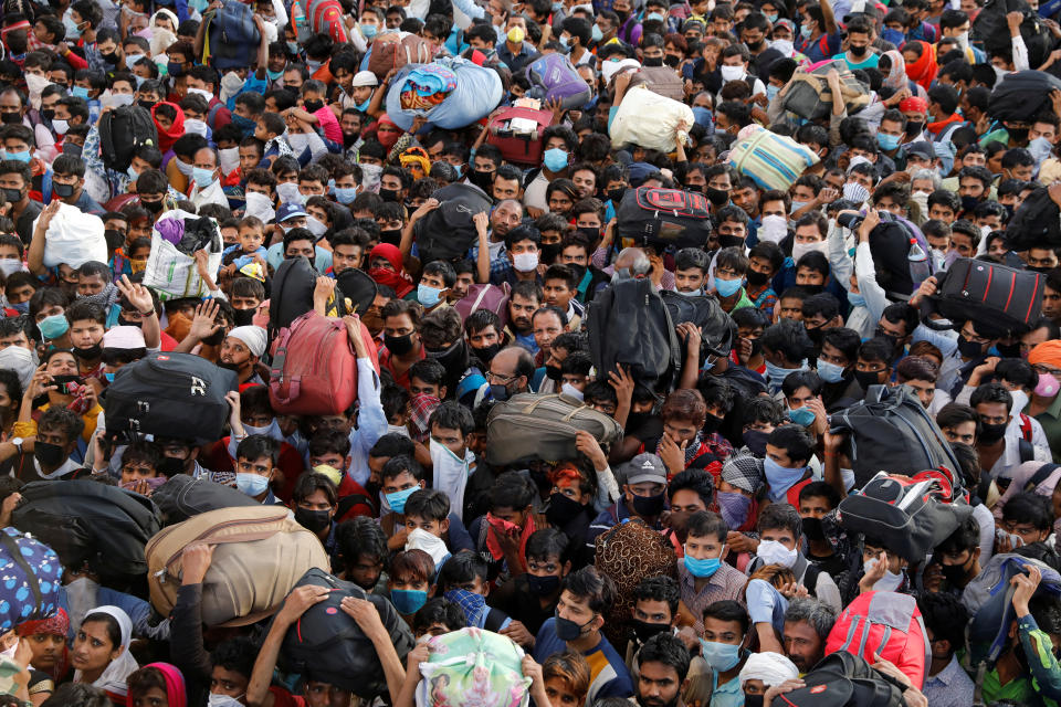 Migrant workers crowd up outside a bus station as they wait to board buses to return to their villages during a 21-day nationwide lockdown to limit the spreading of coronavirus disease (COVID-19), in Ghaziabad, on the outskirts of New Delhi, India March 28, 2020. REUTERS/Anushree Fadnavis