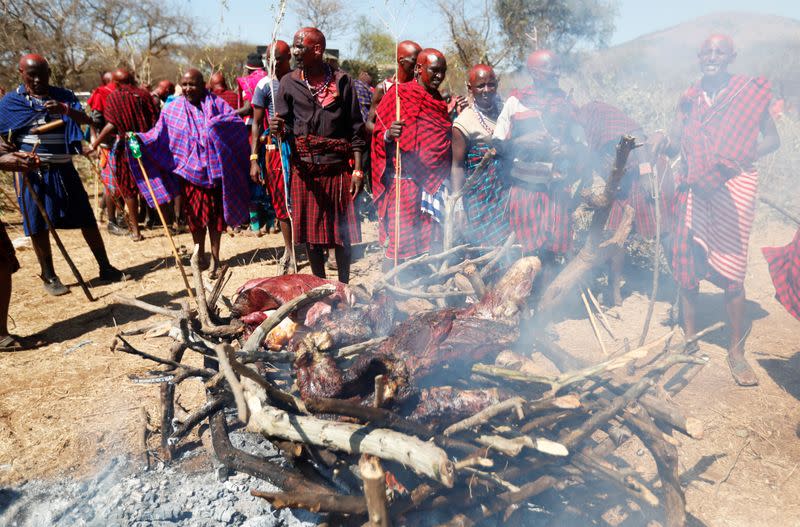 Maasai youth roast meat for the celebrants before attending the Olng'esherr passage ceremony in Maparasha hills of Kajiado