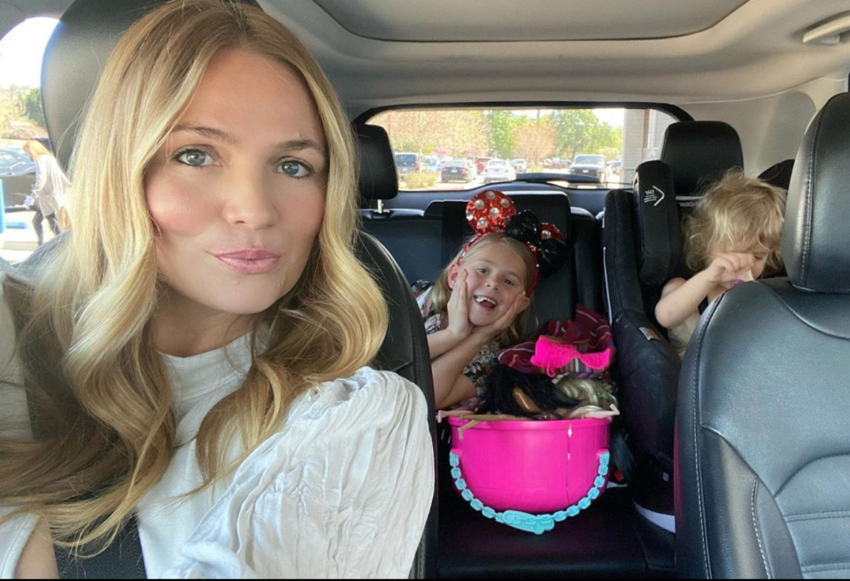 Stephanie McIntosh in front seat of car with daughters in the back